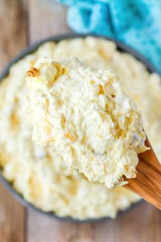 a wooden spoon full of mashed potatoes