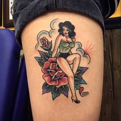 a woman sitting on top of a flower tattoo