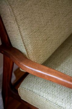 a cat sitting on top of a wooden chair