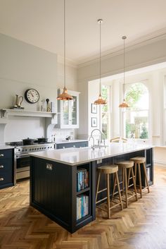 a large kitchen with an island and two bar stools