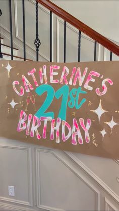 a birthday sign hanging from the side of a stair case