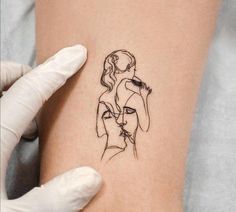 a woman's arm with a tattoo on it that has a drawing of two women