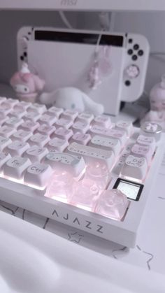 a close up of a keyboard with pink keys and buttons on the keypads