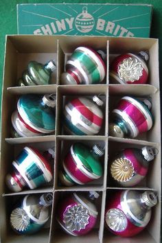 an open box filled with assorted christmas ornaments