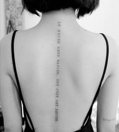 the back of a woman's neck with an inscription on it that reads,