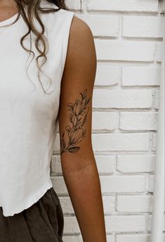 a woman with a tattoo on her arm