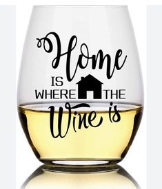 a wine glass with the words home is where the wine is