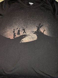 the silhouettes of three people on top of a hill are shown in this t - shirt