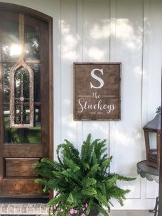 a potted plant sitting in front of a door on the side of a house