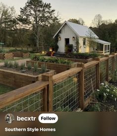 a fenced in garden area with lots of plants