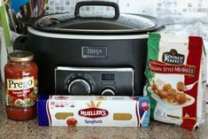 some food is sitting in front of an electric pressure cooker