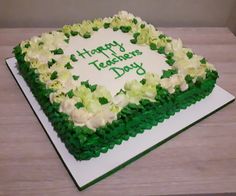 a happy teachers day cake with white and green frosting