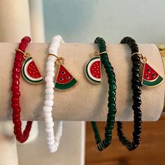 *20% of all proceeds from our Palestine Collection are donated to PCRF (Palestine Children's Relief Fund)* One beaded stretch bracelet with an alloy enamel watermelon slice charm. Bracelet options are solid red, black, white, or green glass 2mm seed beads strung on durable .8 mm elastic cord, with choice of either 1/4 or 1/2 watermelon slice. These handcrafted bracelets are made with love and care by an Egyptian-American mother/daughter team. Bracelets measure approximately 7 inches in  circumference. Custom sizing and colors available upon request, just send us a message! Materials include: 🌸 Glass seed beads 🌸 Alloy enamel charm 🌸 Durable .8mm elastic beading cord Care:  Beaded jewelry is delicate and should be treated with care. To keep your jewelry in good condition, avoid water, lo Beaded Watermelon, Team Bracelets, Watermelon Slice, Beading Cord, Green Gift, Handcrafted Bracelets, Solid Red, Bead Stringing, Enamel Charms