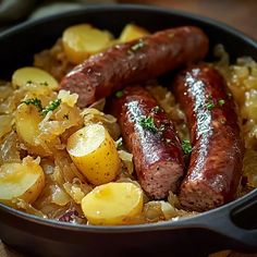 two sausages and potatoes in a skillet