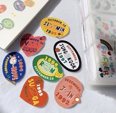 several different colored guitar picks sitting on top of a white table next to a book