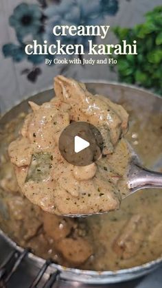 a pan filled with chicken and gravy on top of a wooden stovetop