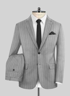 Dive into the realm of understated sophistication with our Napoleon Como Bar Gray Wool Suit. This ensemble is meticulously crafted from a luxurious wool blend, offering a smooth, breathable fabric that's delightfully soft to the touch and ensures comfort without feeling restrictive. Featuring a subtle striped pattern across a palette of gray shades, this suit is a testament to refined style. It’s exquisitely tailored to not only fit comfortably but also to enhance your silhouette, providing enough space for movement while maintaining warmth. Perfect for any scheduled event or special occasion, this suit allows you to express your sartorial elegance effortlessly.  Look Includes    Napolean     Como     Bar     Gray     Wool  Fabric  Two Button Jacket Style  Notch Lapel  Horn Royal Black But Grey Wool Suit, Gray Shades, Refined Style, Button Jacket, Wool Suit, Jacket Buttons, Wool Fabric, Jacket Style, Breathable Fabric