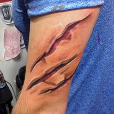 a man with a tattoo on his arm that has an image of a bird in it