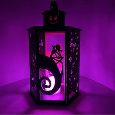 a purple lantern with a silhouette of a person on it and a cat in the background