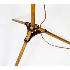 an old wooden table lamp with a chain hanging from it's base and the light turned on