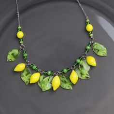 "This Lemon necklace is made of glass in the lampwork technique. This glass fruit necklace is stylish and elegant and will become a bright addition to your outfits! 💕 You will definitely look stunning in this citrus necklace! Dimentions: the necklace length is adjustable, 16\"-19\" inch (40-48cm). The silver colored chain is made of stainless steel and is hypoallergenic. Materials: artist lampwork glass beads, stainless steel and metal fittings. 🎁 This statement yellow necklace will also be a Elegant Green Murano Glass Necklace, Green Glass Pendant Necklace, 2022 Earrings, Lemon Necklace, Spring Costume, Fruit Necklace, Miniature Food Jewelry, Glass Fruit, Fruit Jewelry