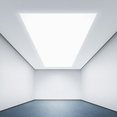 an empty room with a skylight in the ceiling and blue carpet on the floor