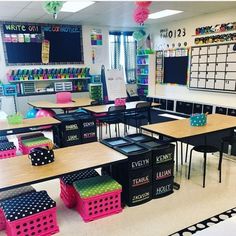 an empty classroom with desks, chairs and chalkboards on the wall in front of them