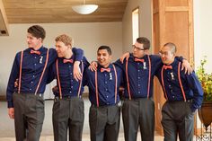 a group of men standing next to each other wearing blue shirts and bow tie ties