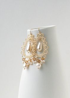 Chandelier Bridal Earrings, Bohemian Wedding Earrings, Filigree Wedding JewelryIntricate patternwork and pearls make a these chandelier earrings a stunner. For the bride looking for a statement earring these fit the bill. + Freshwater Pearls. Glass Teardrop Pearl. 14K GP Chandelier. 14K GF Ear Wire.+ Length: 2.75 inches. Width: 1.25 inches at widest part.+ Earrings take 1 business day to make.+ Your jewelry will come in a jewelry box, tied with a ribbon.➤➤ Have a question about this product, rea Bohemian Wedding Earrings, Chandelier Wedding, Boho Wedding Earrings, Wedding Earrings Chandelier, Pearl Chandelier Earrings, Bridal Earrings Chandelier, Gold Jewellry, Earrings Design, Bridal Earrings Pearl