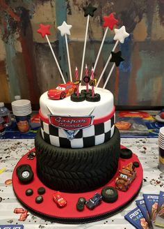 a birthday cake decorated with cars and stars