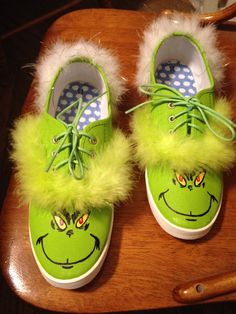 a pair of green shoes with white fur on them