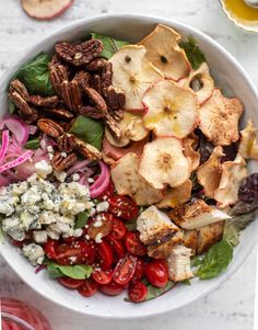 a white bowl filled with salad and nuts