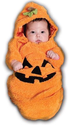 a baby wrapped in a pumpkin costume