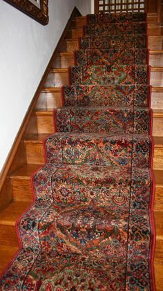 a carpeted staircase leading up to the second floor