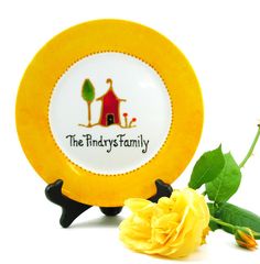 a yellow plate sitting next to a yellow rose