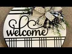 the welcome sign is decorated with ribbon and bows