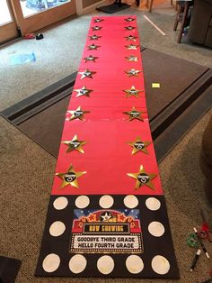 a long red carpeted runner with stars on it