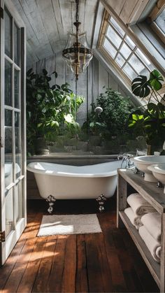 a bathroom with a claw foot bathtub and wooden flooring is shown in this image