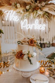 a white wedding cake with flowers on top