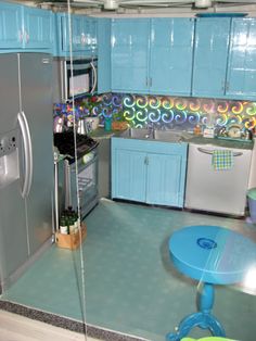 a kitchen with blue cabinets and an icebox in the center, as well as a refrigerator