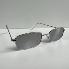 Vintage Y2k 90s 2000s Unique Slim Style Silver Trim Mirror Lens Sunglasses Silver Trim With A Mirror Lens These Sunnies Are Unisex! Uva And Uvb Protection Brand New #Sunglasses #Shades #Sunnies #Fashion Silver Rectangular Sunglasses With Mirrored Lenses, Silver Sunglasses For Summer Streetwear, Trendy Silver Rectangular Sunglasses, 2000s Glasses, Vuarnet Sunglasses, 2000s Men, Alexander Mcqueen Sunglasses, Sunglasses Men Vintage, Oliver Peoples Sunglasses