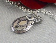 Oval shaped sweet and romantic necklace is 30 inches long. Burnish antique silver oval locket is engraved on both sides, with Victorian style different patterns/motifs. I have accented the locket with sterling silver plated swallow sparrow charm. Necklace is hanging from silver chain and silver lobster clasp. Locket is 21x16mm in size. It opens sideway and has room for two photos! Thanks for looking:) ~Mani Silver Oval Locket Necklace For Vintage Collection, Oval Silver Locket Necklace For Vintage Collection, Antique Silver Oval Locket Necklace For Gift, Ornate Oval Locket Necklace For Gifts, Oval Antique Silver Sterling Locket Necklace, Ornate Oval Locket Necklace Gift, Victorian Personalized Silver Locket Necklace, Victorian Silver Personalized Locket Necklace, Victorian Oval Sterling Silver Locket Necklace