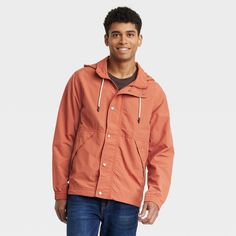 Refresh your wet-weather staples with this Elevated Rain Jacket from Goodfellow & Co™. This stylish elevated jacket in a solid orange color makes a versatile pick for rainy days. Made from water- and wind-resistant material, this hooded jacket features a lightweight construction to keep you dry, warm and comfortable at all times. The full-length zipper and snap closures allow for easy layering, while the elastic cuffs provide a snug fit. Plus, the front pockets allows you to carry small essentia Casual Weatherproof Spring Outerwear, Casual Waterproof Spring Outerwear, Casual Weatherproof Fall Raincoat, Casual Weatherproof Raincoat For Fall, Orange Outerwear With Pockets For Outdoor Activities, Casual Waterproof Raincoat, Casual Cotton Raincoat With Pockets, Casual Orange Long Sleeve Windbreaker, Orange Hooded Windbreaker For Fall