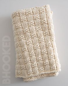 a white knitted dishcloth laying on top of a table