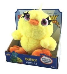 a yellow stuffed toy with big eyes in a box