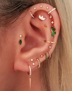 a woman's ear with several piercings on it