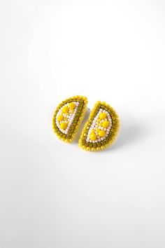 "These vibrant eye-catching earrings are adorned with yellow colorful beading. Adding a touch of playfulness and elegance to any outfit. Made with high quality material and attention to detail our Slice Lemon Earrings are perfect statement piece to express your unique personality.  * Hand beading * Super lightweight  * Stud earrings * Push back * Onesize  * Length 2.5\" Width 2\" * Weight of each earring 0.12 oz 🫧 HEAD TO OUR WEBSITE FOR MORE 📲 shopandreamboutique.com ANDREAM DETAILS ✿ These earrings are 100% handmade by artisan women in the heart of Colombia. They're hand beaded. Super lightweight to wear all day!  ✿ All artisan earrings are handmade with love and care. Each pair of earrings are unique and one of a kind. Since each piece is handmade, each pair may vary in color and appe Beaded Fruit, Lemon Earrings, Farmer Market, Vibrant Eyes, Fruit Earrings, Gift Ideas For Her, Artisan Earrings, Lemon Slice, Women Earrings