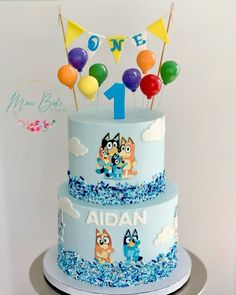 a birthday cake decorated with cartoon characters and balloons