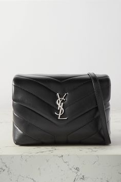 The name of SAINT LAURENT's bag references the iconic relationship between Loulou de la Falaise and the house's founder. It's been made in Italy from quilted black leather and decorated with the label's logo plaque. It has a detachable strap so you can carry it as a clutch, too. Ysl Lulu Bag, Lulu Bag, Bag Inspiration, Fashion Book, Favorite Handbags, Handbags Affordable, Fancy Bags, Saint Laurent Bag, Canvas Shoulder Bag