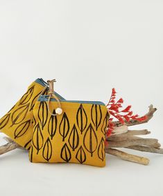 This beautiful minimal leaf print fabric wallet is made from a beautiful mustard yellow cotton canvas and it is the perfect size to carry the bare necessities like your change, keys, lipstick and anything that needs a zipper. The print is entirely made with hand carved original block prints. The colors are vibrant and the colorful zipper makes it even more stunning. This block printed zipper pouch is a unique and thoughtful gift for any occasion, or a great way to treat yourself.  As this is a h Yellow Coin Purse With Zipper For Everyday Use, Handmade Yellow Pouch Bag, Trendy Yellow Rectangular Pouch, Everyday Yellow Rectangular Pouch, Yellow Zipper Pouch Coin Purse For Daily Use, Cheap Yellow Rectangular Pouch, Yellow Rectangular Wallet With Removable Pouch, Fabric Wallet, Zipper Purse